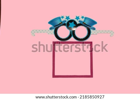 mask above frame, creative art design on pink background, party time, invitation, copy space