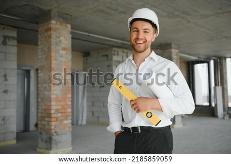Portrait of man architect at building site. Confident construction manager wearing hardhat. Successful mature civil engineer at construction site with copy space Royalty-Free Stock Photo #2185859059