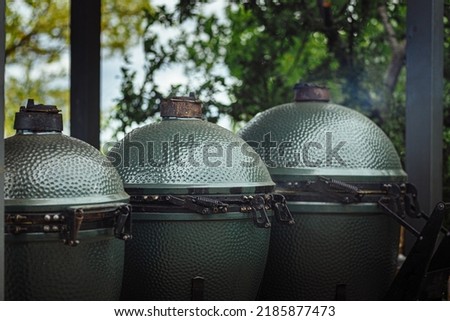 Kamado-style green color ceramic charcoal barbecue egg shape cooker Royalty-Free Stock Photo #2185877473