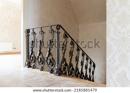 wooden stairs with metal wrought iron railings in a new house Royalty-Free Stock Photo #2185881479