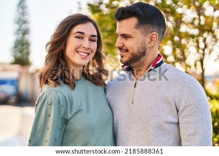 Man and woman smiling confident hugging each other standing at park