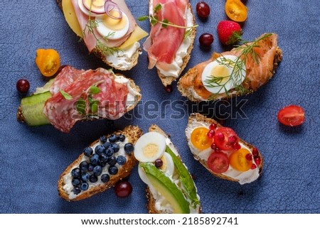 Assortiment of different kind of sandwiches with cream cheese and healthy topping Royalty-Free Stock Photo #2185892741