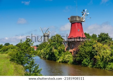 The twin windmills of Greetsiel at the north sea, East Frisia, Lower Saxony, Germany Royalty-Free Stock Photo #2185908511