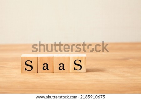 Saas. SaaS. The letters DX drawn on wooden blocks.
