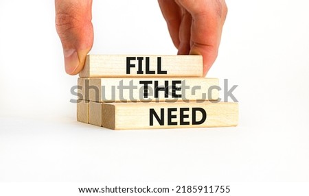 Fill the need symbol. Concept words Fill the need on wooden blocks on a beautiful white table white background. Businessman hand. Business, finacial and fill the need concept. Copy space.