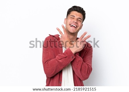 Young caucasian man isolated on white background smiling and showing victory sign