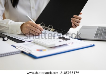 The secretary is writing the memo of the working message in the file.