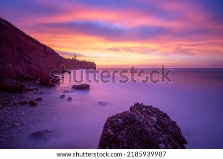 long exposure shot of a beach and beautiful colors of sunrise