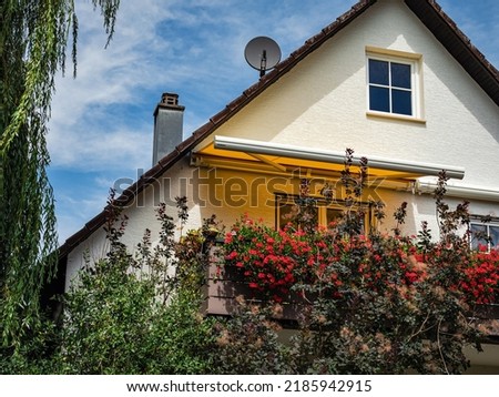 Cozy, clean and tidy village house. Sliding awning awning on the balcony. Sunny colors.