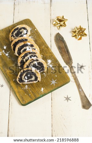 poppy seed rolls with an old dessert knife on aged wooden table