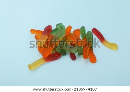 Jelly colored worms on a blue background