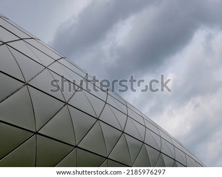 modern architecture facade with dramatic clouds