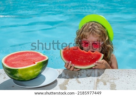 Kid boy playing in swimming pool. Summer vacation concept. Summer kids portrait with watermelon in pool water.