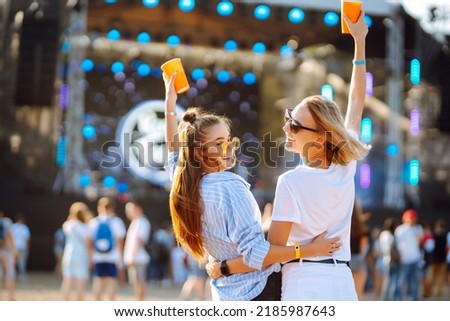 Two young woman with beer at beach party. Summer holiday, vacation concept. Friendship and celebration concept. Royalty-Free Stock Photo #2185987643