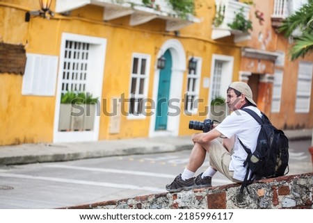 Male tourist taking pictures of the beautiful at Cartagena de Indias walled city
