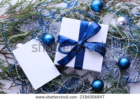 christmas greeting card mockup. fir branches with Christmas decorations and an envelope with a white blank for text