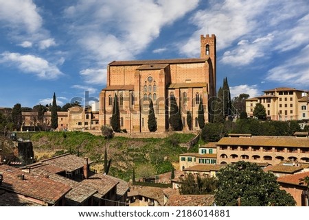 Siena, Tuscany, Italy: cityscape with the medieval church Basilica of San Domenico on the hill in the old town of the city 

 Royalty-Free Stock Photo #2186014881