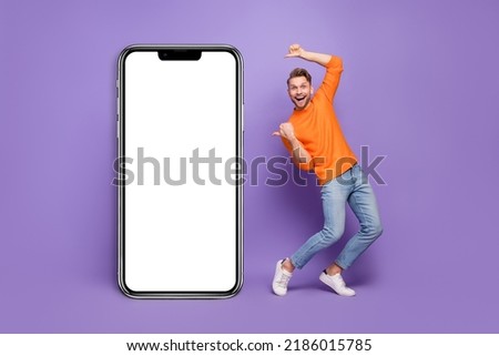 Full size photo of good mood excited dancing male promote cellphone card promo isolated on violet color background