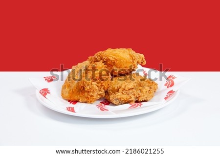 Fried Chicken 3 pieces served in a cutting board on grey background side view of fastfood Royalty-Free Stock Photo #2186021255