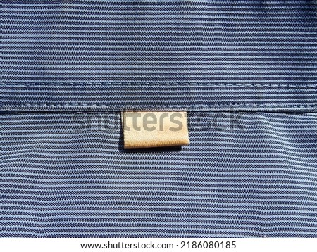 Label for shirt collar size on blue fabric background