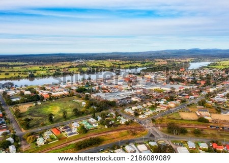 Taree town downtown shopping district and residential suburbs around on shores of Manning river Marting bridge - aerial townscape. Royalty-Free Stock Photo #2186089089
