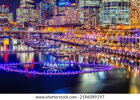 Scenic brightly illuminated Darling Harbour waterfront in sydney city CBD at sunset with water fountain floaging on Coockle bay. Royalty-Free Stock Photo #2186089197