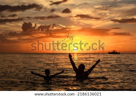 beautiful sunset on the ocean boy with dad happy and laughing