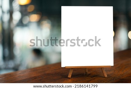 White paper counter menu on blurred restaurant background.