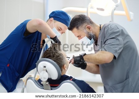 Surgeon and nurse during a dental operation. Anesthetized patient in the operating room.Installation of dental implants or tooth extraction in the clinic. General anesthesia during orthodontic surgery Royalty-Free Stock Photo #2186142307