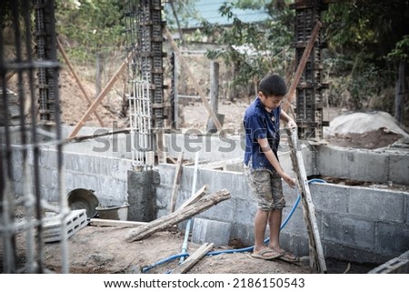 Children working at construction site. Concept against child labor and human trafficking for world day against child labor concept.