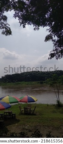 Picture of a place to relax by the big river with a view of the blue sky and white clouds