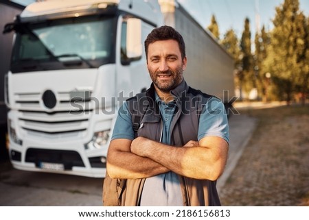Portrait of confident truck driver on parking lot looking at camera. Royalty-Free Stock Photo #2186156813