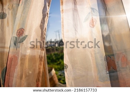 an open window with elegant curtains
