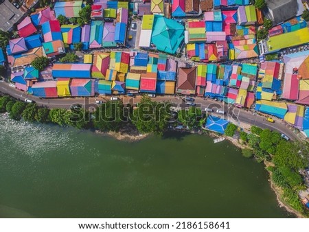 Aerial top view of a colorful village in Tangerang City, Indonesia called "Kampung Berkelir" in the morning in 2018 which is close to the Cisadane River.