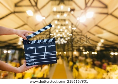 Man hands holding movie clapper. Film director concept. camera show viewfinder image catch motion in interview or broadcast wedding ceremony, catch feeling, woman hand hold a Film Slate over bokeh