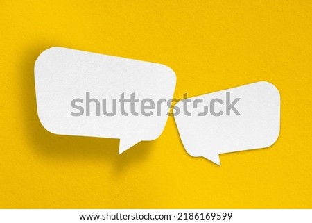 speech balloon shape white paper isolated on yellow background Communication bubbles. Royalty-Free Stock Photo #2186169599