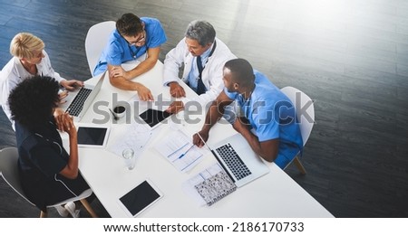 Team of medical workers sitting and meeting with laptops around table. Doctors and staff discussing papers and test results. Healthcare experts handling daily tasks and duties Royalty-Free Stock Photo #2186170733