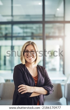 Confident manager, leader and creative boss with her arms crossed in a powerful, assertive and proud stance. Portrait of smiling, happy and business woman ready for success with arms folded in Royalty-Free Stock Photo #2186170977