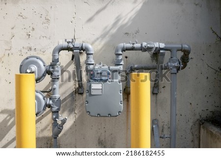 Natural gas line meter for residential multi-dwelling building or home. Outdoor meter measuring and displaying the actual usage number in cubic feet. Vancouver, BC, Canada. Selective focus. Royalty-Free Stock Photo #2186182455