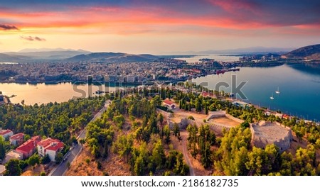 Wonderful morning cityscape of Chalcis town, Greece, Europe. Astonishing summer view from flying drone of Karababa Castle. Amazing sunrise on Euboea island, Greece, Europe.