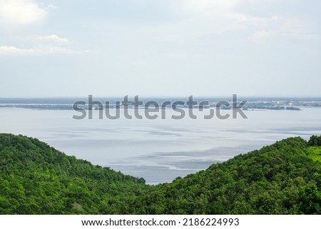 View of the Volga River in Tatarstan, Russia. Endless blue river in summer. Calm natural landscape.