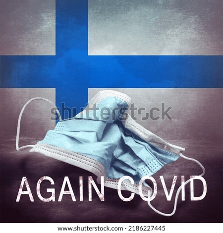 Inscription Again Covid and a crumpled medical mask on the flag of Finland. Return of the coronavirus. New jump in incidence. Omicron and Dedta strain. Danger of a viral infection. Medical concept