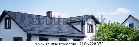 The dark-colored roof of a new residential private house Royalty-Free Stock Photo #2186228375