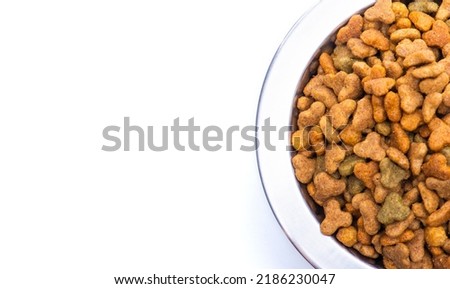 Close-up of balanced dry pet food in a metal plate for cats and dogs. High quality photo