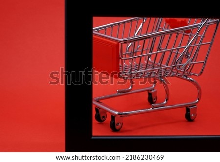 empty shopping trolley on a red background
