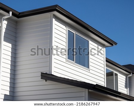 Brand new residential townhouse. Public social housing. Blue sky and sun shadows. Royalty-Free Stock Photo #2186267947