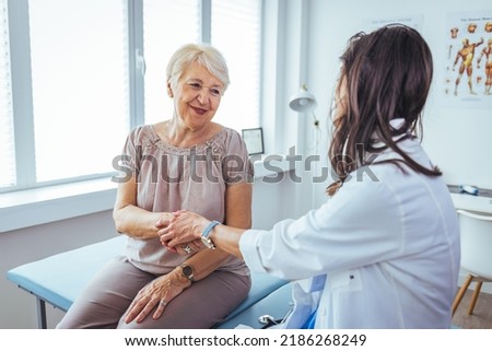 Friendly female doctor's hands holding female patient's hand for encouragement and empathy. Partnership trust and medical ethics concept. Doctor giving hope. 