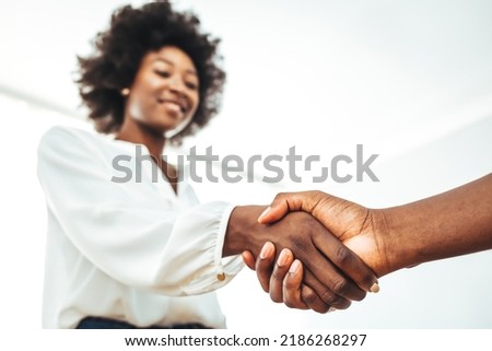 Recruiter shaking successful smiling businesswoman candidate hand at meeting, congratulating with getting new job, manager making great deal with customer, diverse business partners greeting