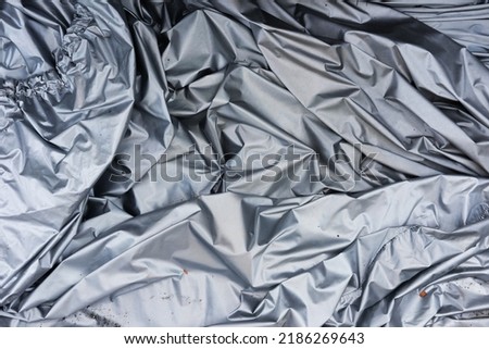 The car cover has intricate folds