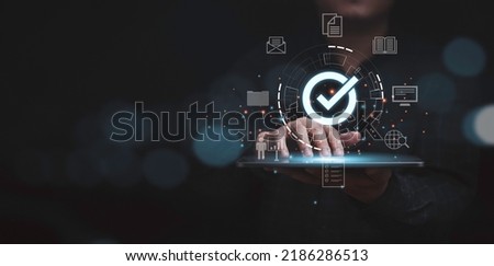 Businessman using laptop with correct sign mark and document icon for online approve  paperless and quality assurance concept. Royalty-Free Stock Photo #2186286513